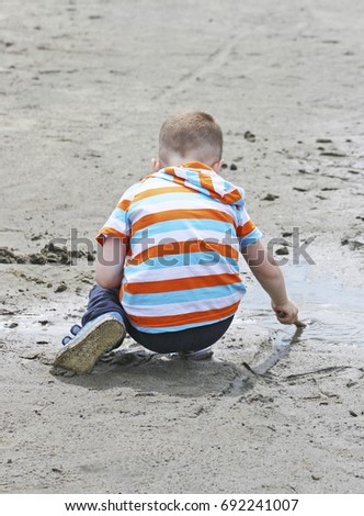 Similar – Foto Bild Baby spielt am Strand.