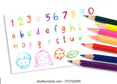 Children's painting colored pencil, colorful handwriting crayon on white paper, kids alphabet drawing toy. Student handicraft homework.