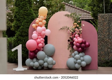 Children's photo zone with a lot of balloons. Decorations for a One year old Girls Birthday party. Concept of children's birthday party. Colourful party