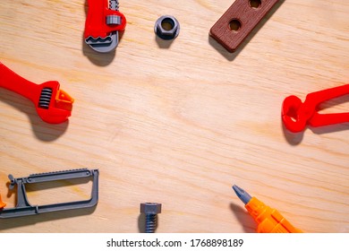children's plastic tools lie on a sheet of plywood