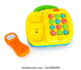 Children's Plastic Toy Phone. Isolated On White Background With Shadow Reflection. With Clipping Path. Childish Telephone With Buttons Which Make Sounds. Educational Telephone For Little Children