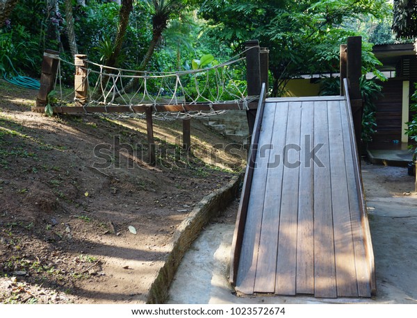 Children\'s\
play bridge in the  natural park in\
Thailand.