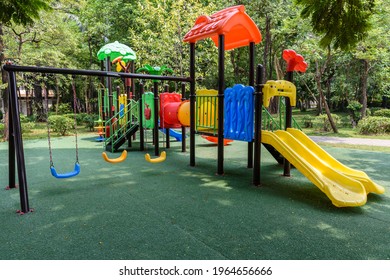 The children's playground is colorful on a green yard. - Shutterstock ID 1964656666
