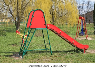 Children's playground in the park. New and modern children's slide. Renovation of infrastructure for children in the city - Powered by Shutterstock