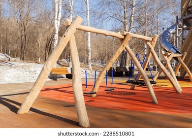 Children's playground in the park. Swings and carousels for children outdoors..