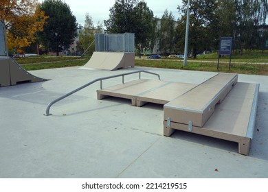Children's playground in the skatepark for skateboarders and roller skates consisting of miniramp, ramp - picnic table, quarter, grindbox, rail