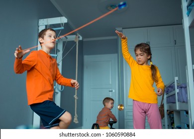 Childrens playing with yo-yo toy. Home plays.