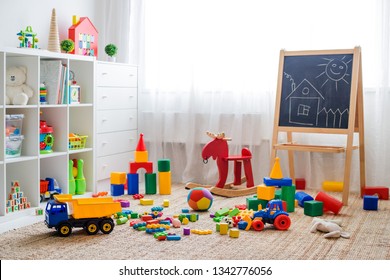 Children's playroom with plastic colorful educational blocks toys. Games floor for preschoolers kindergarten. interior children's room. Free space. background mock up chalkboard - Shutterstock ID 1342776056