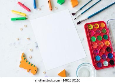 Children's Preschool Art Supplies Surrounding Blank Paper Mockup Concept Flat Lay For Montessori Class