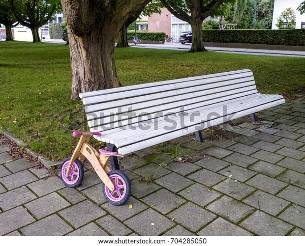 Childrens Pushbike Leaning Against Bench Small Stock Photo Edit