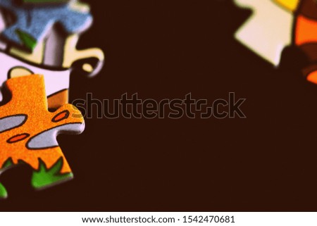 Children's puzzles on a dark background close up. Retro style toned