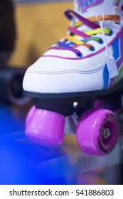 Childrens quad skate rollerskates in skate store in shop window display. Skates with four wheels and front brake for roller disco.