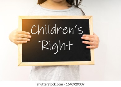 Children's right concept with a young girl hold the chalkboard.  - Shutterstock ID 1640929309
