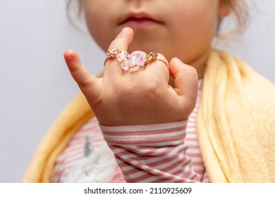 Children's Rings And Jewelry On The Fingers Of A Little Girl, Selective Focus.  A Young Fashionista Shows Her Jewelry.