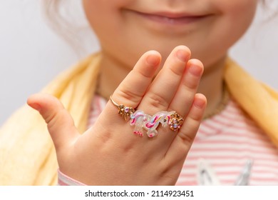 Children's Rings And Jewelry On The Fingers Of A Little Girl, Selective Focus.  A Young Fashionista Shows Her Jewelry.