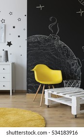 Children's Room With Chalkboard Wall And White And Yellow Furniture