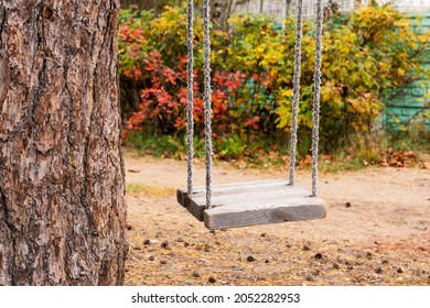 children's rope swing hanging alone and motionless under a tree, childhood, nostalgia, memories. - Shutterstock ID 2052282953