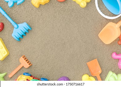 Children's Sandbox With Various Toys For The Game. Sand Yellow Background. Concept Of A Family Vacation Near The Sea With Children