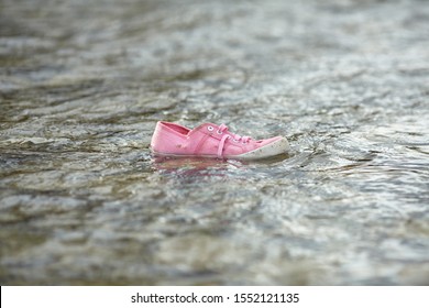 Children's Shoes By The Sea. Homeless Child. Refugee Problem. Concept Of Finding A Better Life.