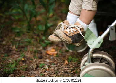 Children's Shoes With Laces. A Child Is Sitting In A Stroller.