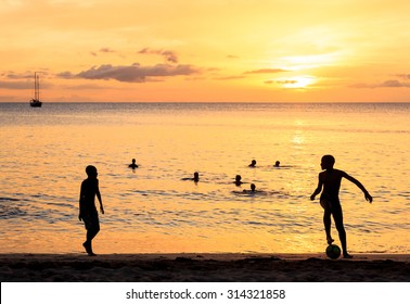 Childrens silhouette playing soccer at Tarrafal beach in Santiago island in Cape Verde - Cabo Verde - Powered by Shutterstock