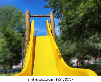 childrens slide in the park  with green trees - Shutterstock ID 1654860727