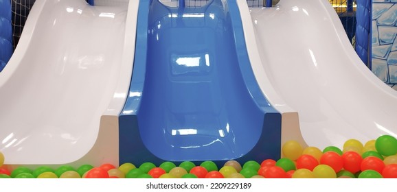 Children's slides with plastic balls in the pool, an entertaining playground. Close-up. - Shutterstock ID 2209229189