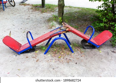 A children's swing is broken in half by vandals. - Powered by Shutterstock