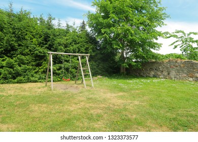 Childrens Swing Set In Green Park. Eco Backyard