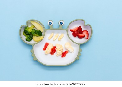 Children's Tableware.Soft Eco Plastic Tableware With Mixed Vegetable. Healthy Nutrition For Kid, Self Feeding. Top View Of Silicone Plate With Spoon Finger Food For Kid.