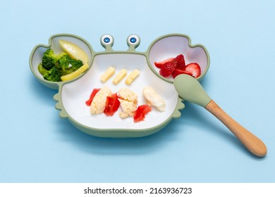 Children's Tableware.Soft Eco Plastic Tableware With Mixed Vegetable. Healthy Nutrition For Kid, Self Feeding. Top View Of Silicone Plate With Spoon Finger Food For Kid.