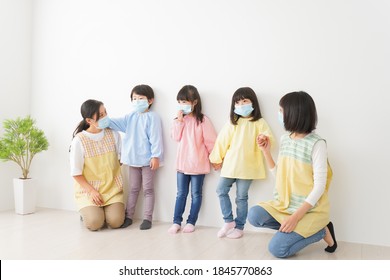 Children's Teacher Playing In Kindergarten With A Mask On