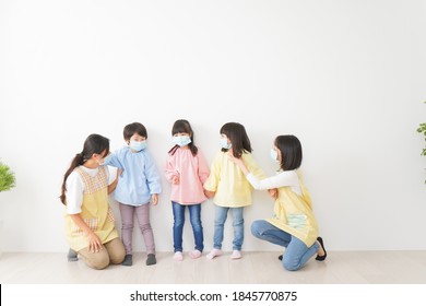 Children's Teacher Playing In Kindergarten With A Mask On