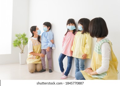 Children's Teacher Playing In Kindergarten With A Mask On