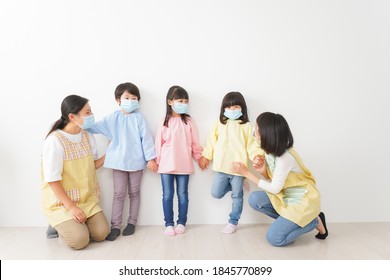 Children's Teacher Playing In Kindergarten With A Mask On