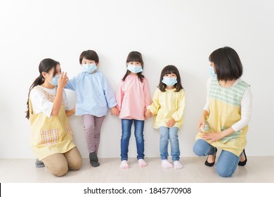 Children's Teacher Playing In Kindergarten With A Mask On