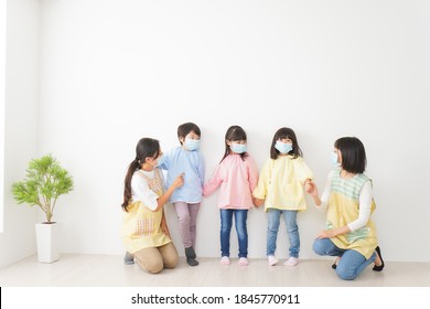 Children's Teacher Playing In Kindergarten With A Mask On