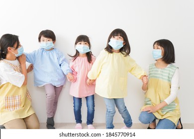 Children's Teacher Playing In Kindergarten With A Mask On