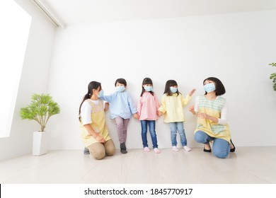 Children's Teacher Playing In Kindergarten With A Mask On