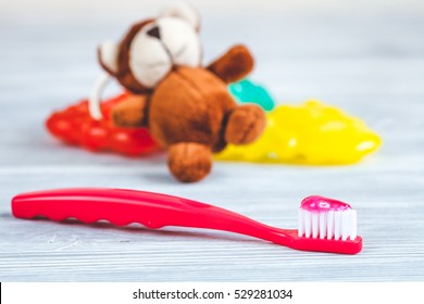 children's toothbrush oral care on wooden background - Powered by Shutterstock