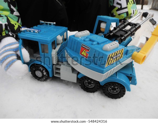 Children\'s toy cars. Car Models. Kids toys.\
The child is played by an\
excavator.\
