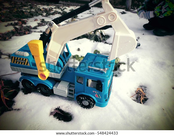 Children\'s toy cars. Car Models. Kids toys.\
The child is played by an\
excavator.\
