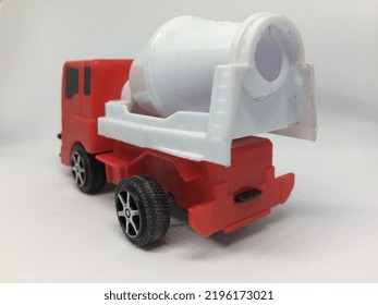 Children's Toy Cement Mixer Truck With A White Body And A Red Truck Head. Isolated On A White Background.