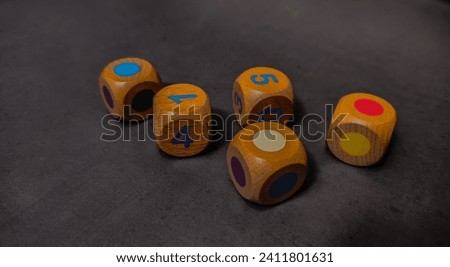 Children's toy color and number dice on a gray background