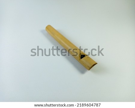 Children's toy flute made of bamboo is played by blowing and there is a small bamboo to be pulled that makes a little sound 