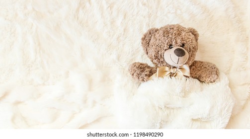 children's toy sleeps under the blanket. copy space. Selective focus. Kids. - Powered by Shutterstock