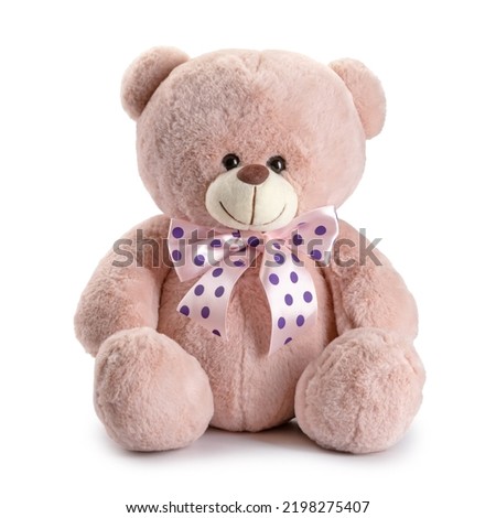 Children's toy teddy bear with pink bows in dots isolated.