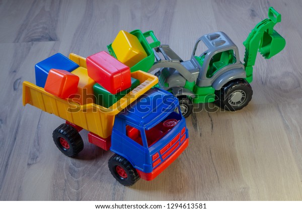 Children\'s toy. Truck with colorful cubes.\
Tractor excavator.
