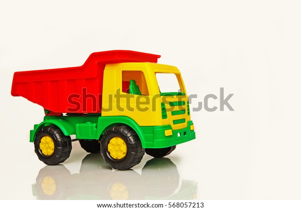 children\'s toy truck,dump truck, plastic\
multicolored on white\
background