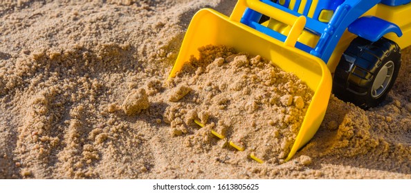 Children's Toys Machine Shovel Rake In The Sandbox On The Sand On A Summer Day, A Long Banner, A Hobby Of Playing Outdoors Digital Detox